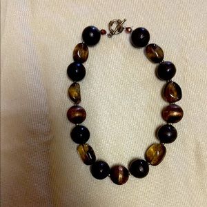 Brown and gold necklace.